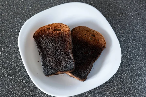 皿にトースターから焼けたパン 悪い料理 — ストック写真