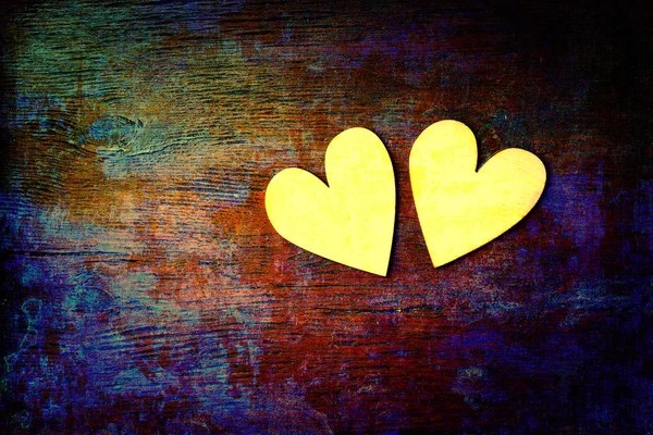 Liefde en romantiek. Twee harten op abstracte veelkleurige achtergrond met houten textuur. Creatieve kunst achtergrond — Stockfoto