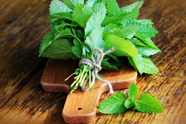 Fresh mint leaves herb on rustic wooden table — Stock Photo, Image