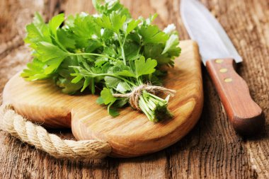 ahşap kesme tahtası üzerinde bıçak ile organik taze maydanoz. sığ dof makro