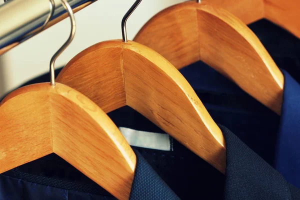 Row of mens suits hanging in closet — Stock Photo, Image