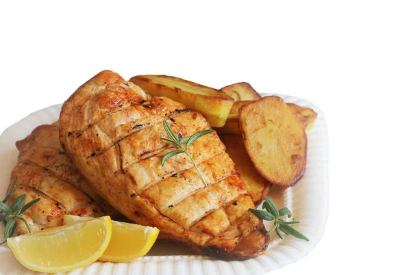 Grilled chicken breast with fried potato and lemon on white background — Stock Photo, Image