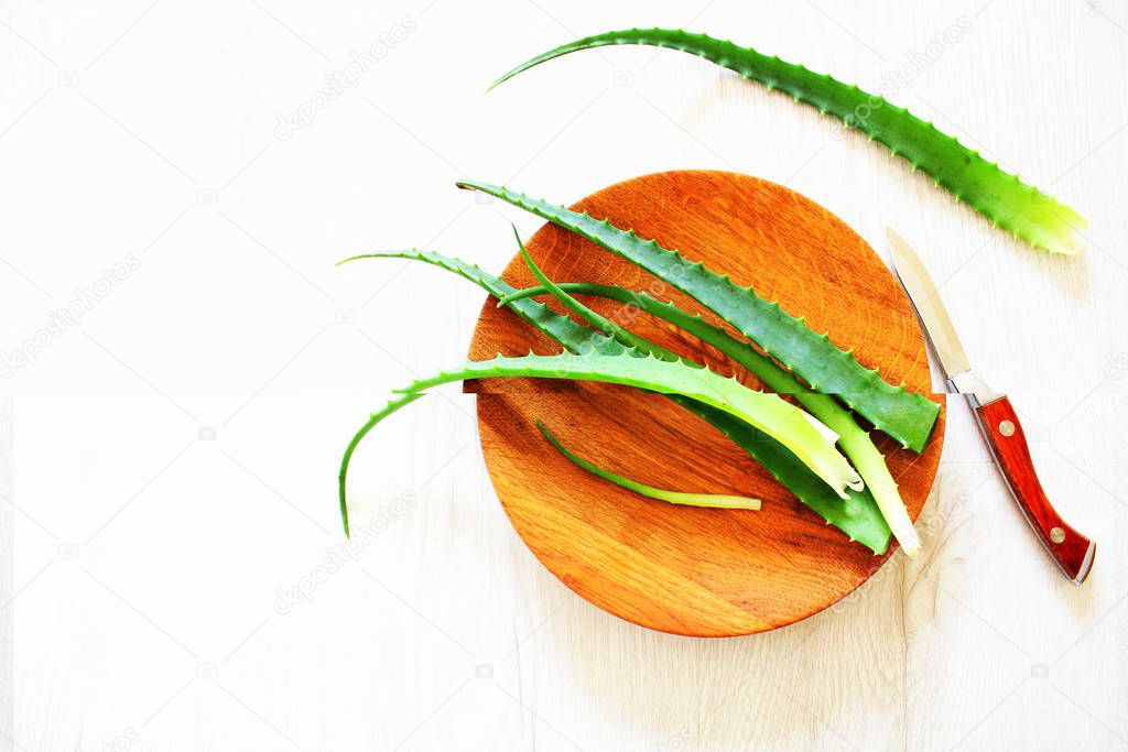 Lleaf of fresh aloe vera on wooden plate , natural clear gel as the star beauty ingredient for skin care