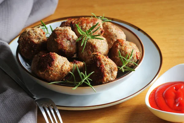 Roasted meatballs with tomato sauce , delicious meat cutlets on wooden table — Stock Photo, Image