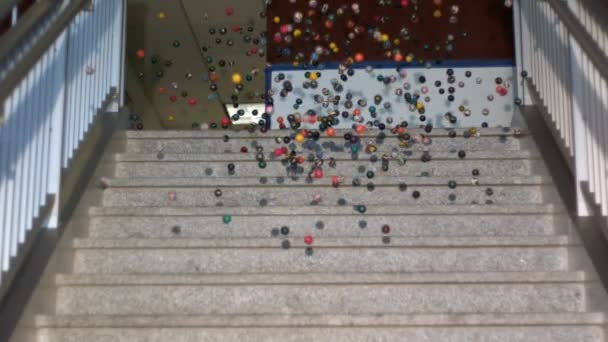 Slow motion bouncy balls swarming down stairs — Stock Video
