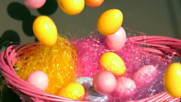 Slow motion eggs into easter basket — Stock Video