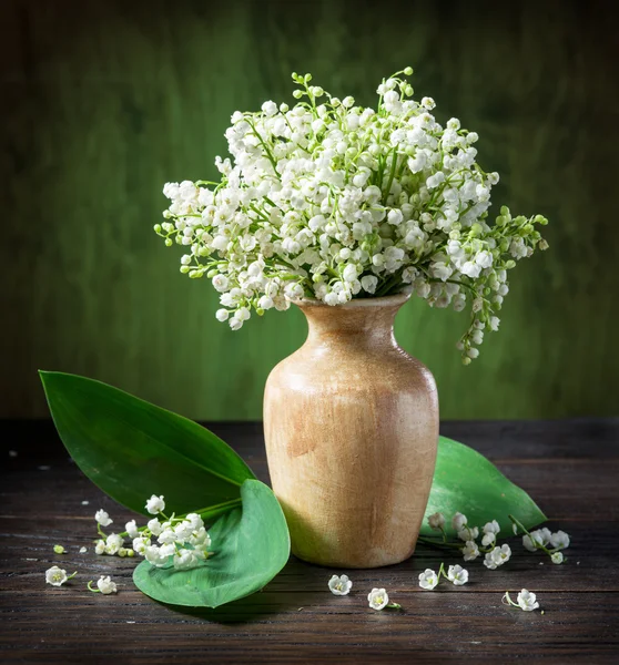 Lily of the valley bouquet on the wooden table. — Stock Photo, Image