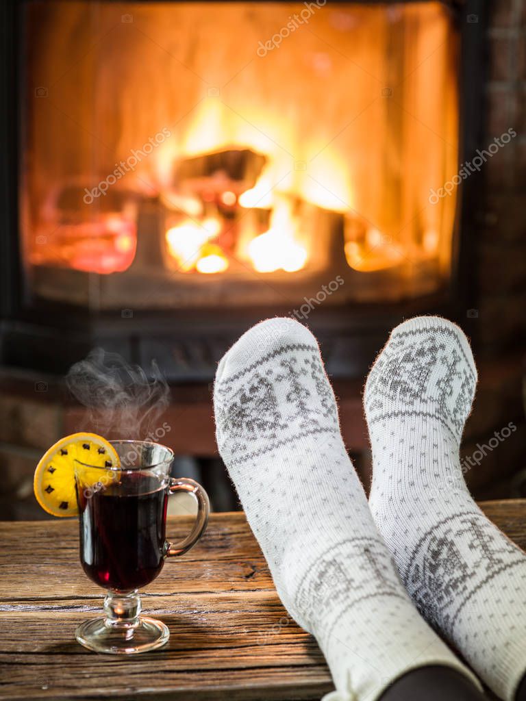 Warming and relaxing near fireplace with a cup of hot wine. — Stock