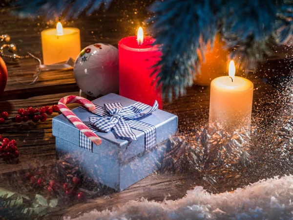 Gift boxes, candle lights and frozen window. Christmas backgroun