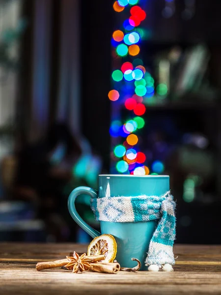 Cup with magic colorful lights and spices. Christmas background.