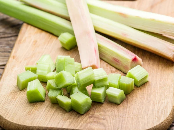 Edible rhubarb stalks on the wooden table. — Stock Photo, Image