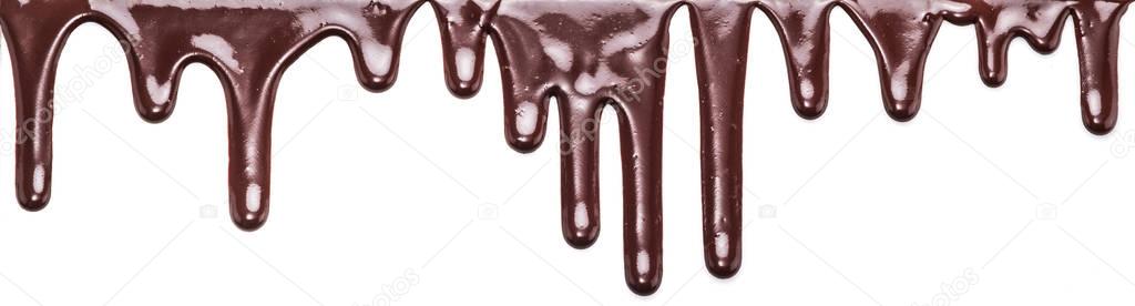 Flowing chocolate drops or drops of chocolate glaze isolated on 
