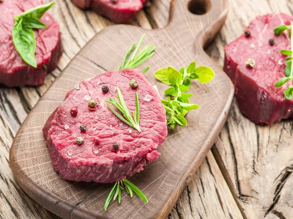 Piece of beef tenderloin on the wooden cutting board. — Stock Photo, Image