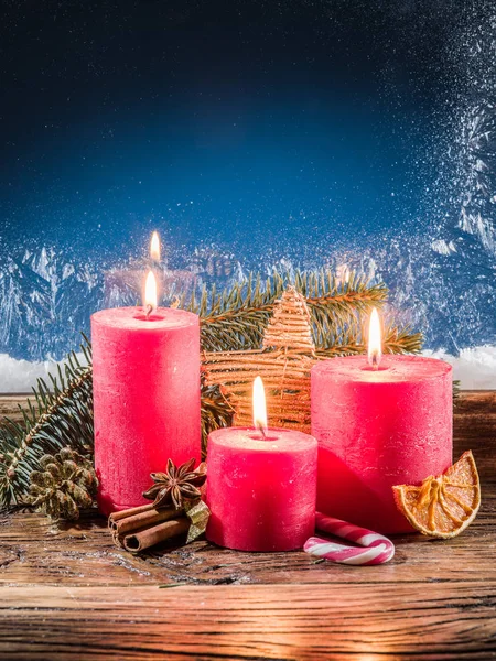 Cristmas candle lights and frozen window. Christmas background. — Stock Photo, Image