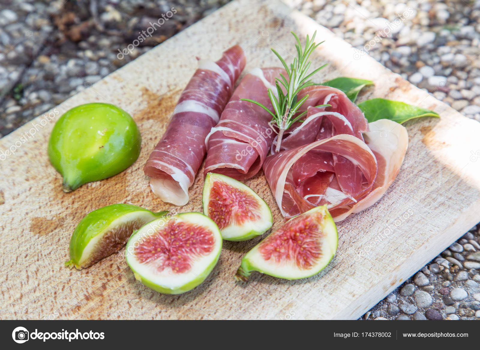 Ripe fig fruits and bacon or prosciutto. Food to the d Stock