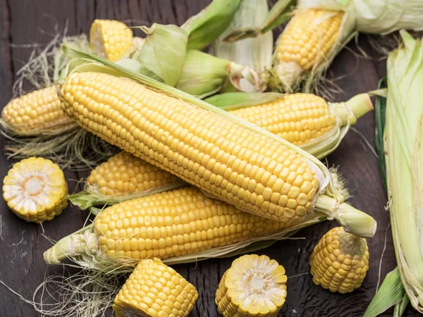 Ear of maize or corn on the dark wooden background. — Stock Photo, Image