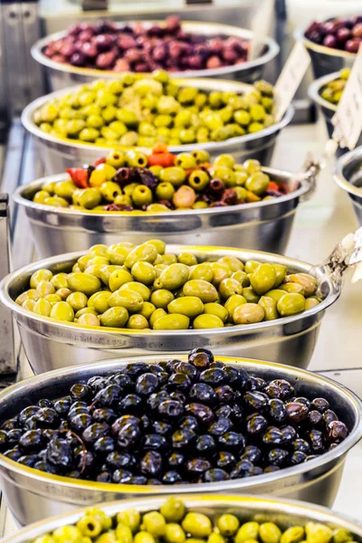 Different cured table olives in the bowls. — Stock Photo, Image