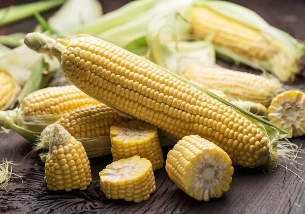 Ear of maize or corn on the dark wooden background. — Stock Photo, Image