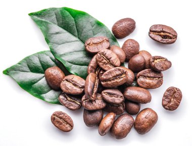 Roasted coffee beans and leaves on white background. clipart