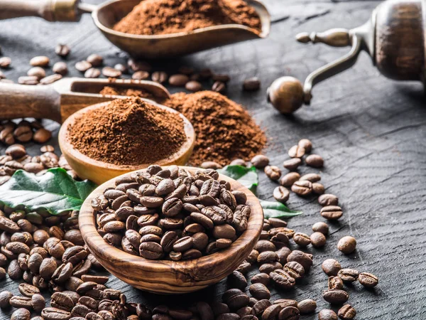 Roasted coffee beans  and ground coffee on wooden table. — Stock Photo, Image