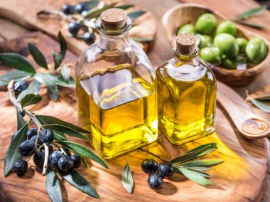 Zeytinyağı ve çilek zeytin ahşap tepsi üzerinde vardır. 