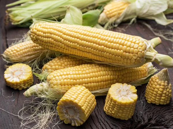 Ear of maize or corn on the dark wooden background. — Stock Photo, Image