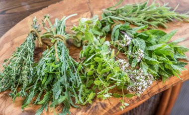 Fresh herbs on the wooden table. clipart