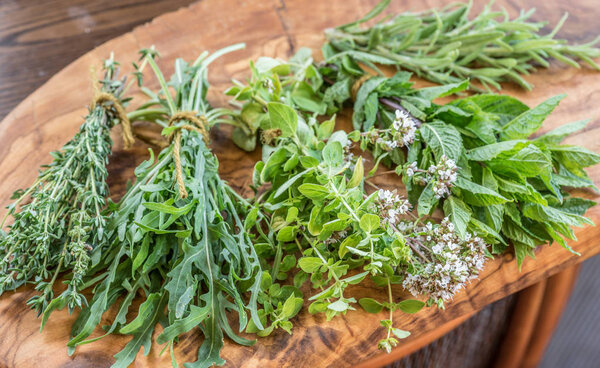 Fresh herbs on the wooden table.