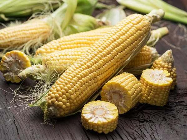 Ear of maize or corn on the dark wooden background. — Stock Photo, Image