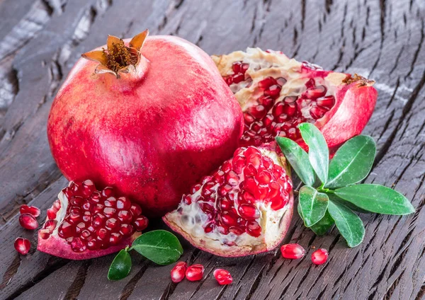 Ripe pomegranate fruits on the wooden background. — Stock Photo, Image