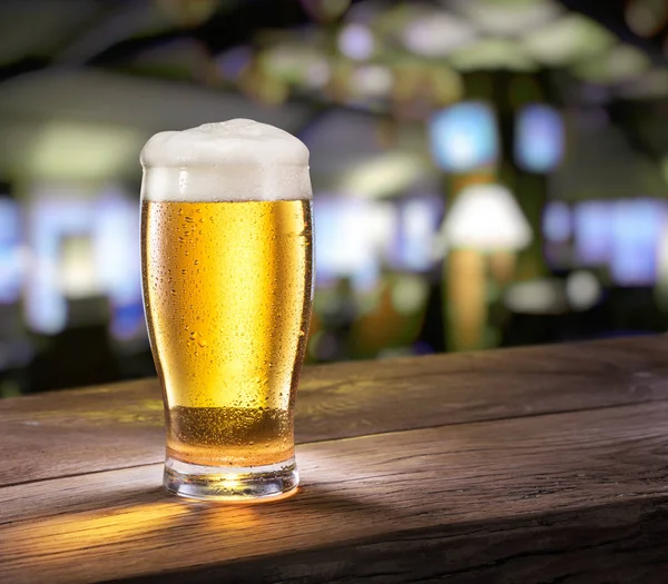 Copo gelado de cerveja leve no balcão do bar . — Fotografia de Stock