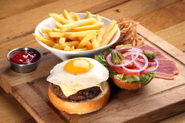 Burger with beef steak and fried egg.