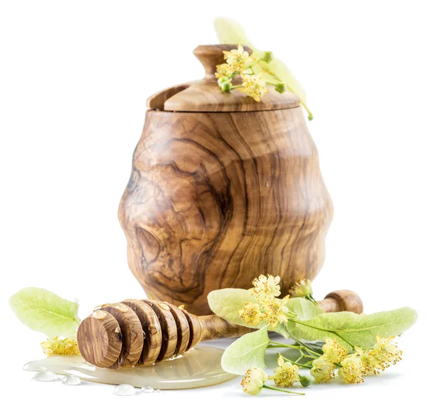 Wooden pot full of fresh linden honey and linden flowers. — Stock Photo, Image