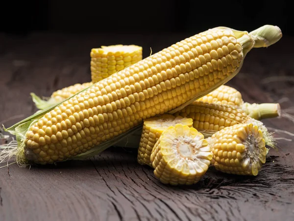 Ear of maize or corn on the dark wooden background. — Stock Photo, Image