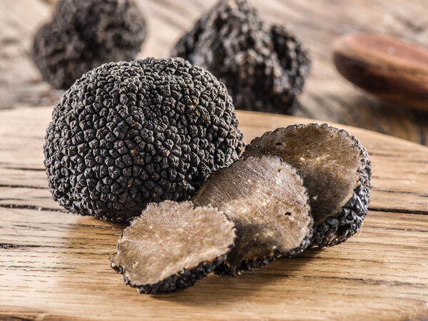 Black truffles on the old wooden table.