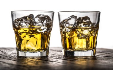 Whiskey glasses or glasses of whiskey with ice cubes on the wood clipart