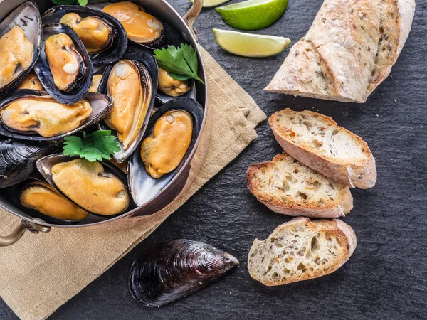 Mejillones en bandeja de cobre sobre fondo de grafito . — Foto de Stock