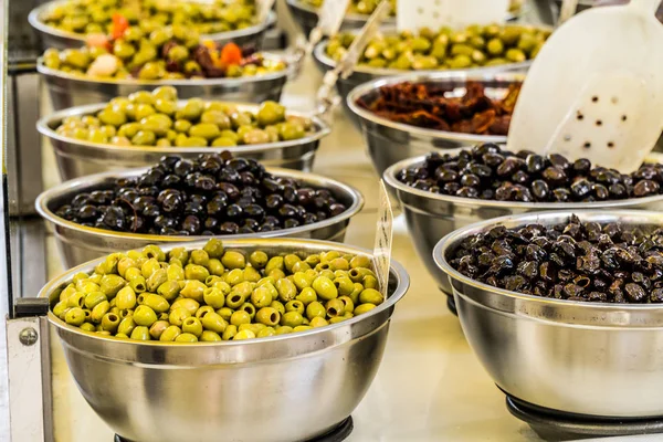 Different cured table olives in the bowls. — Stock Photo, Image