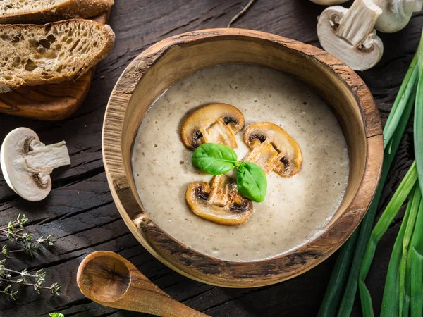 Cream soup with mushrooms on wooden table. Top view. — Stock Image Cream soup with mushrooms on wooden table. Top view. Royalty Free Stock Images