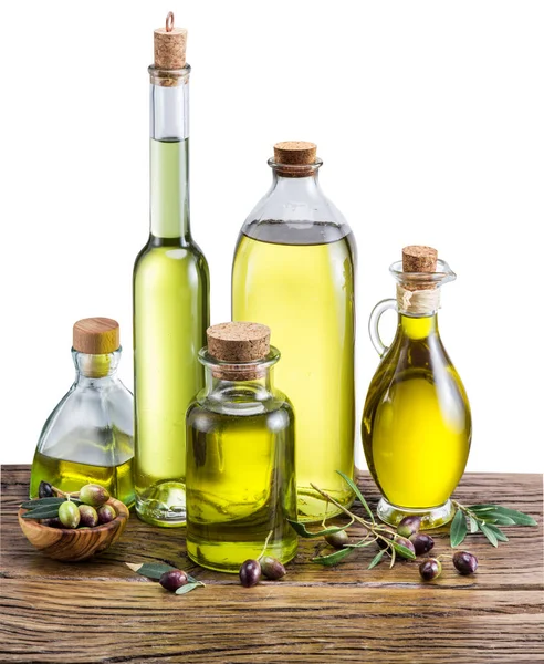 Olive oil and berries on the wooden table. — Stock Photo, Image