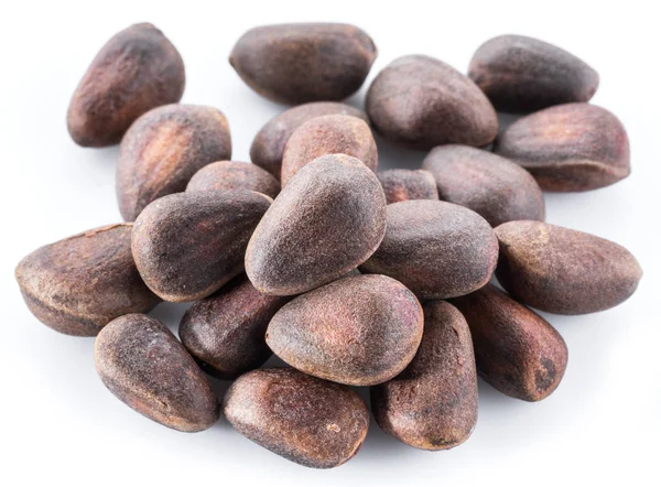 Unshelled pine nuts on the white background. Organic food. — Stock Photo, Image