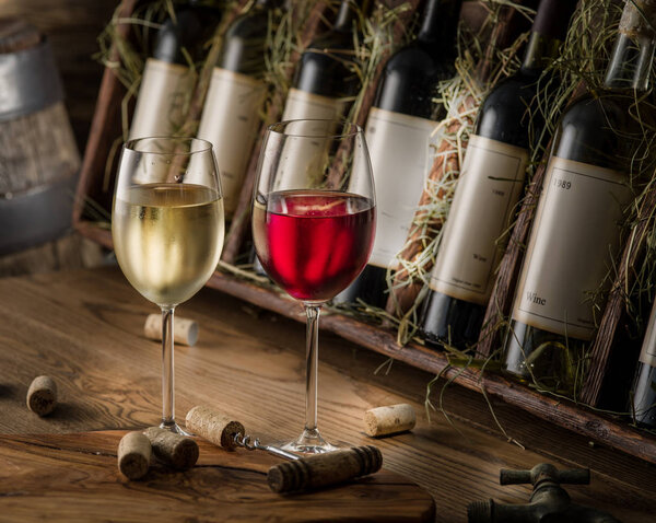 Wine bottles on the wooden shelf.
