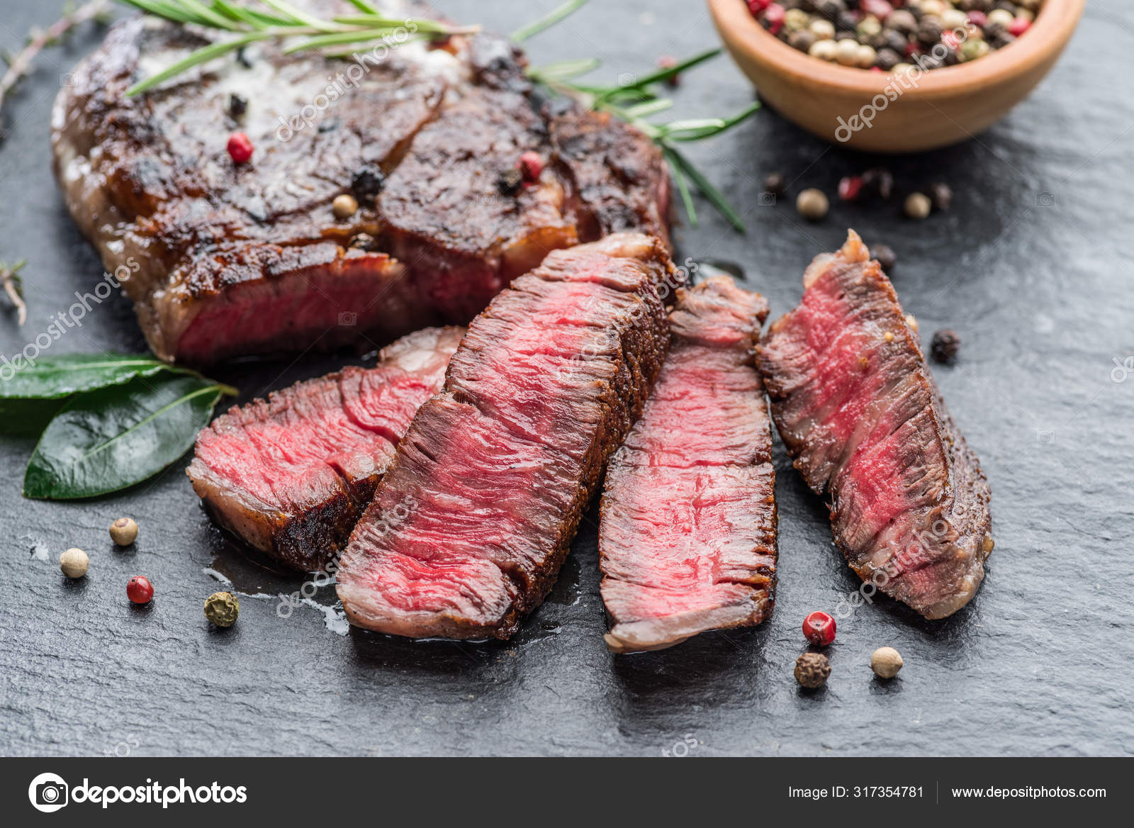 Medium rare Ribeye steak with herbs on graphite board. ⬇ Stock Photo, Image  by © Valentyn_Volkov #317354781