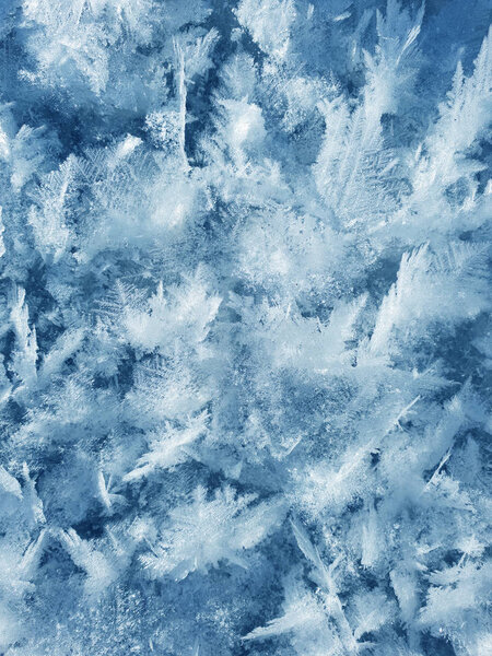 Snow crystals form beautiful snow pattern on frozen icy river. S