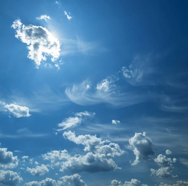 Some light cumuliform clouds in the clean blue sky. — Stock Photo, Image