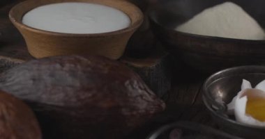 Kamera, tiramisu keki yapmak için gereken malzemelerin üzerinde yavaşça hareket ederken, sonunda tiramisu kekine odaklanıyor. 4K video. Blackmagic Sineması 6K.