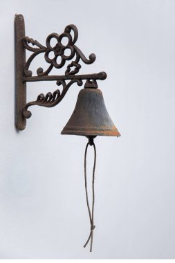 Beyaz duvarda asılı metal çan