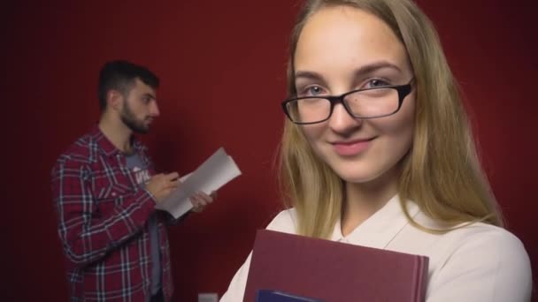 Atraktivní studentka blondýna dívka s brýlemi na červené — Stock video