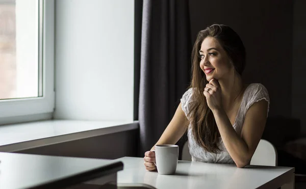 Atractiva mujer morena con taza de café blanco — Foto de Stock