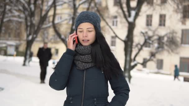 Молода брюнетка дівчина розмовляє по телефону — стокове відео